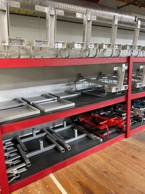 Cart parts staged on shelves in the assembly area