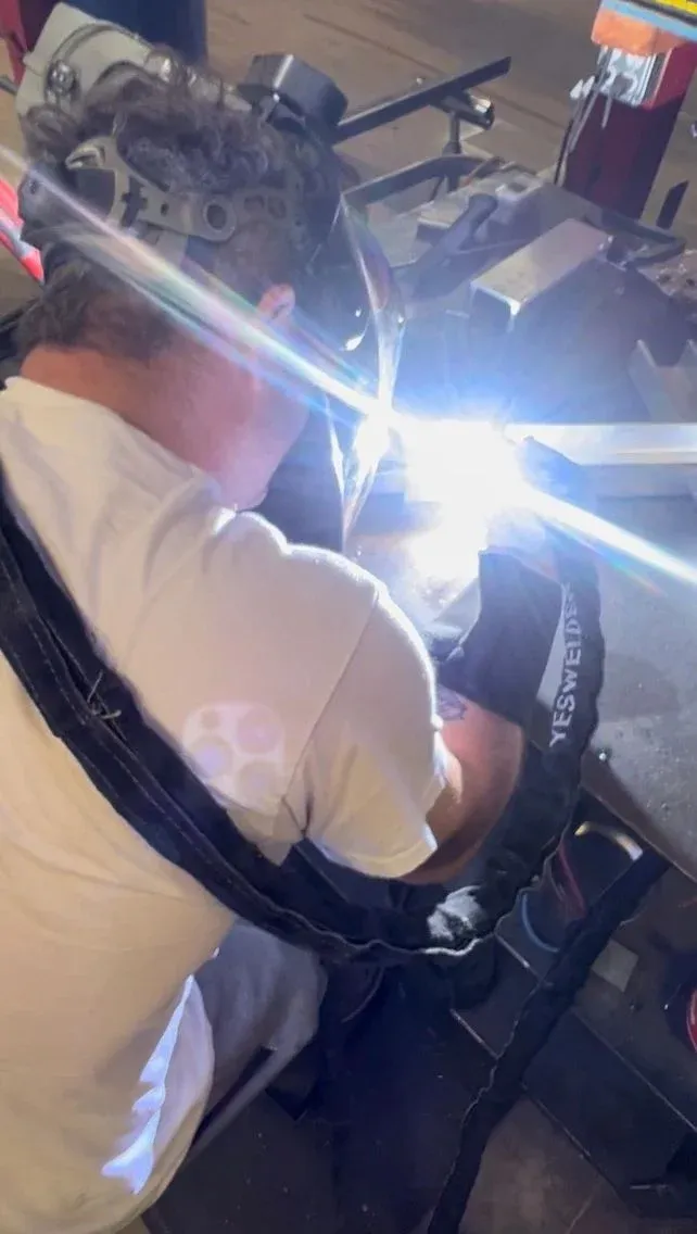 Welder joining a frame in the RoadMaster shop
